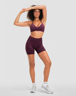 Elevate Sculpting Mid Waist Scrunch Shorter Shorts in Winter Plum Red, full-length front view with matching halter sports bra