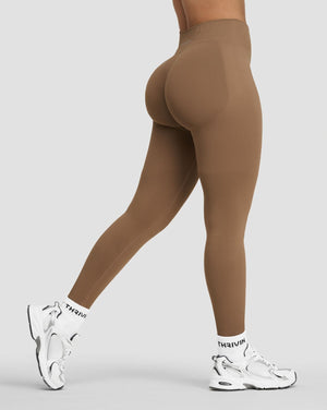 Elevate Sculpting Mid Waist Scrunch Leggings in Toffee, side view of leg mid-stride