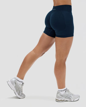 Elevate Sculpting Mid Waist Scrunch Shorter Shorts in Midnight Navy Blue, back view with scrunch seam and Thrivin logo