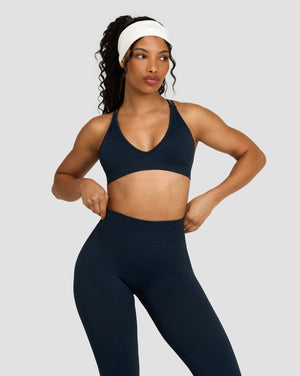 Elevate Sculpting Seamless High Apex Bra in Midnight Navy Blue, front view with matching leggings, hands on hips