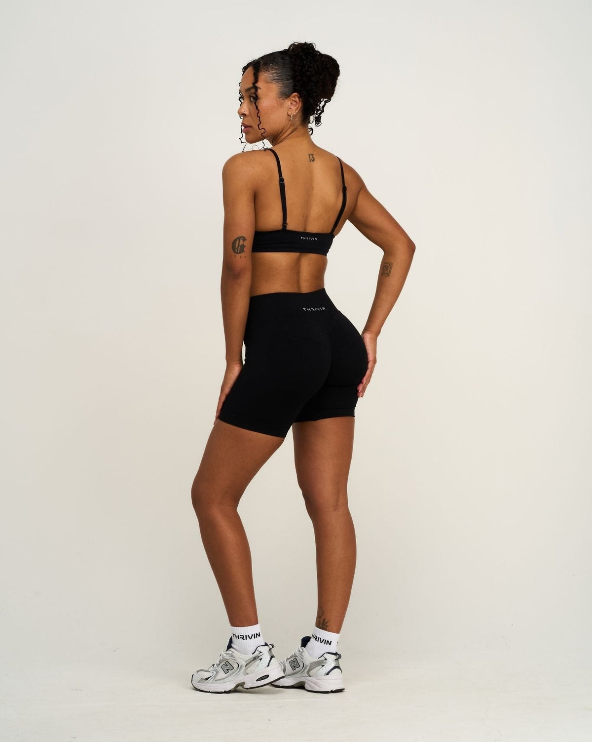 Elevate Sculpting Seamless Scoop Neck Bra in Night Black, back three-quarter view with matching shorts