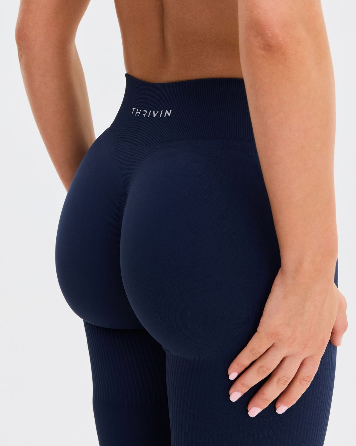 Elevate Sculpting Mid Waist Scrunch Leggings in Midnight Navy Blue, back close-up of seamless fit and THRIVIN waistband
