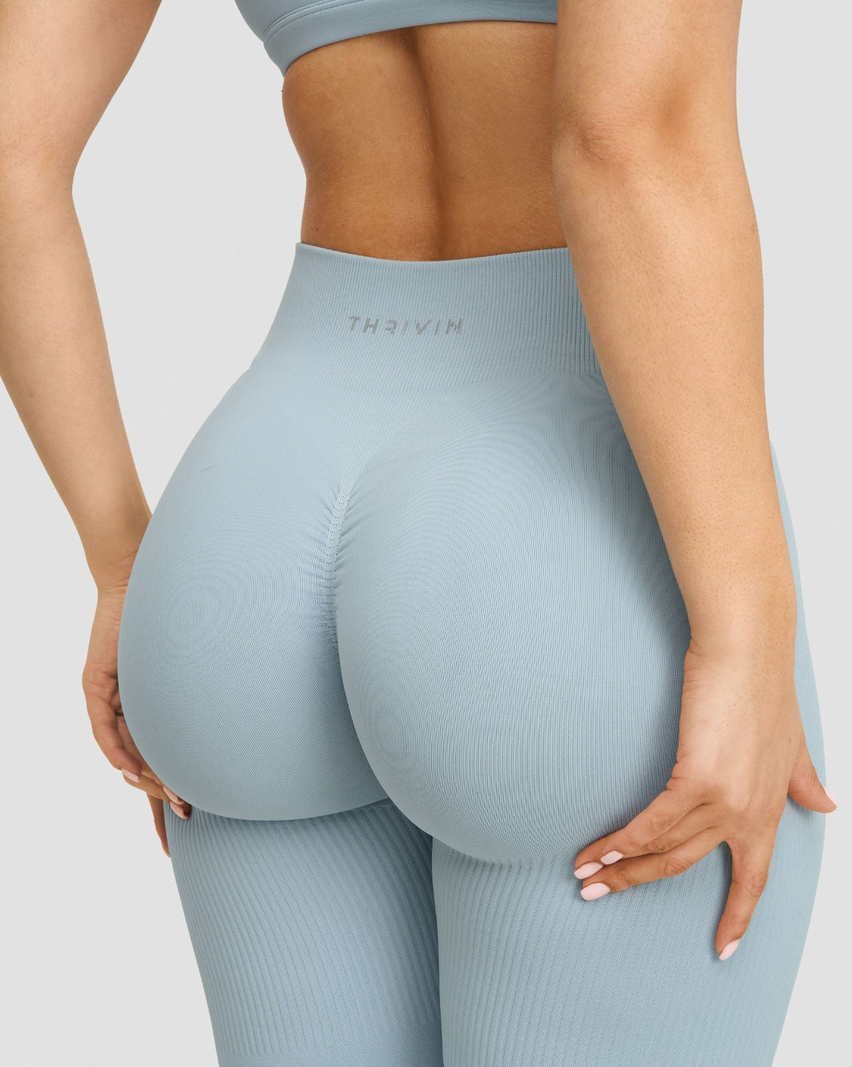 Elevate Sculpting Mid Waist Scrunch Leggings in Blue Haze, back close-up of Thrivin logo and scrunch seam