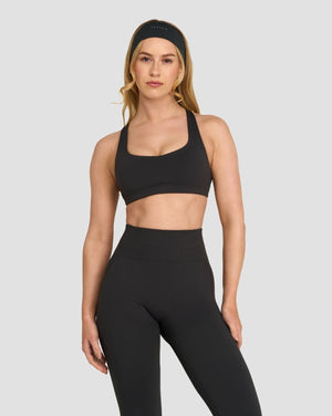 Elevate Sculpting Medium Impact Multiway Bra in Charcoal Grey, front view styled with leggings and headband
