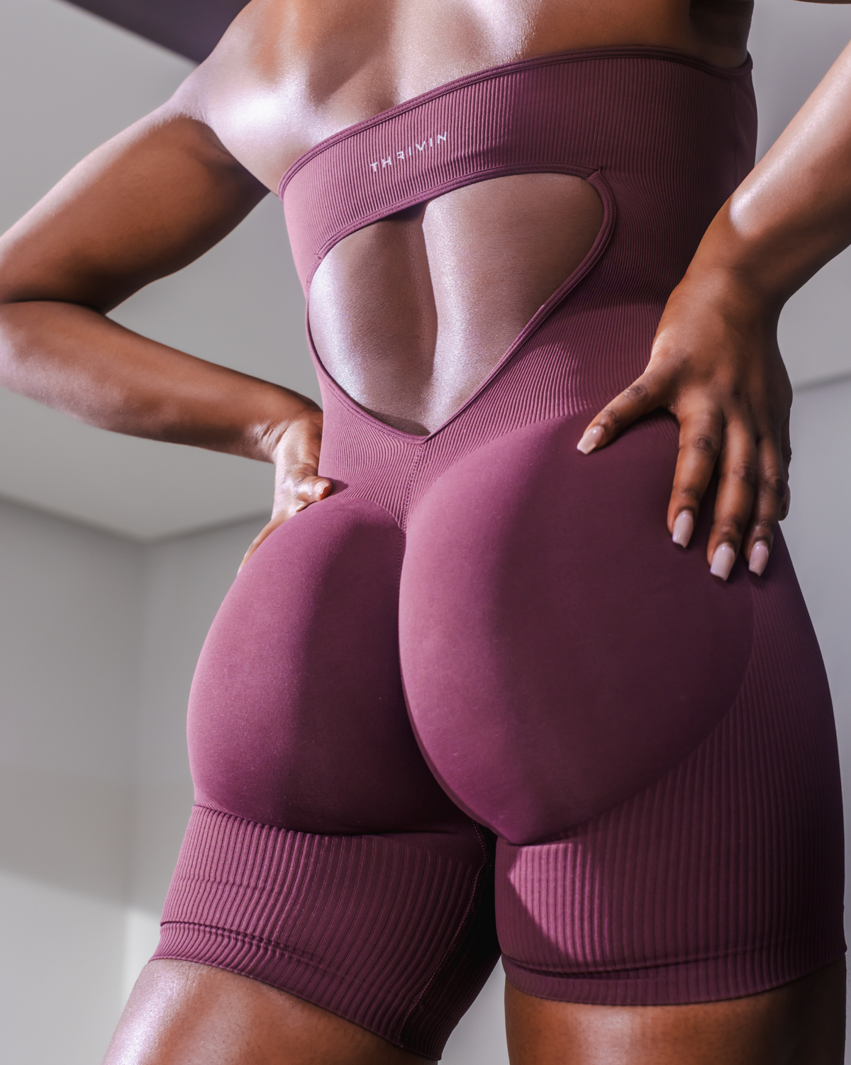 Elevate Sculpting Halterneck All In One in Dark Mauve, back close-up of open back with THRIVIN logo