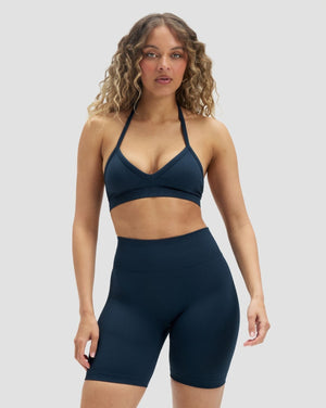 Elevate Sculpting High Waist Scrunch Shorts in Midnight Navy Blue, front view styled with a halter bra