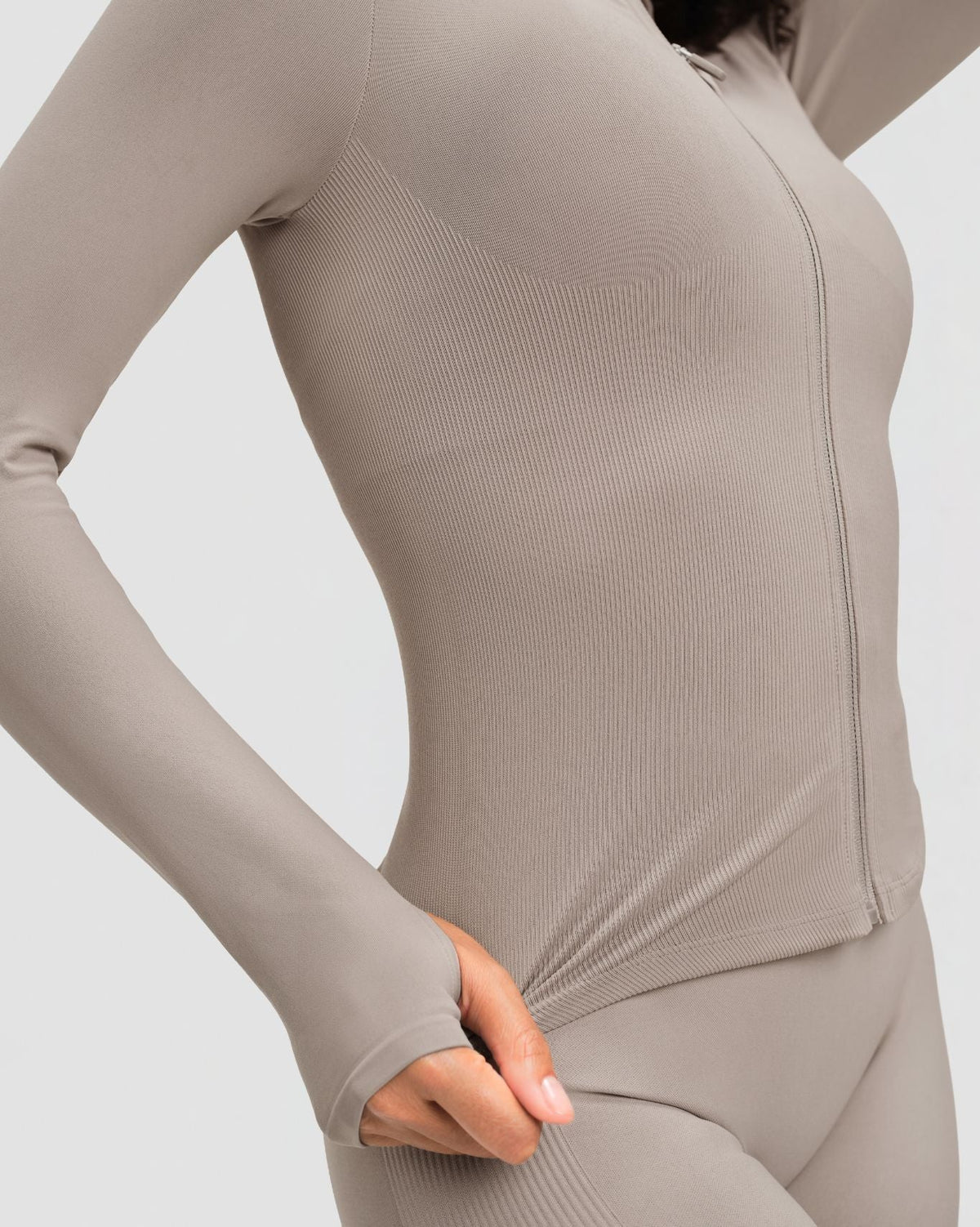 Elevate Compression Long Sleeve Jacket in Latte Grey, close-up of ribbed knit, full-length zip and thumbhole cuff