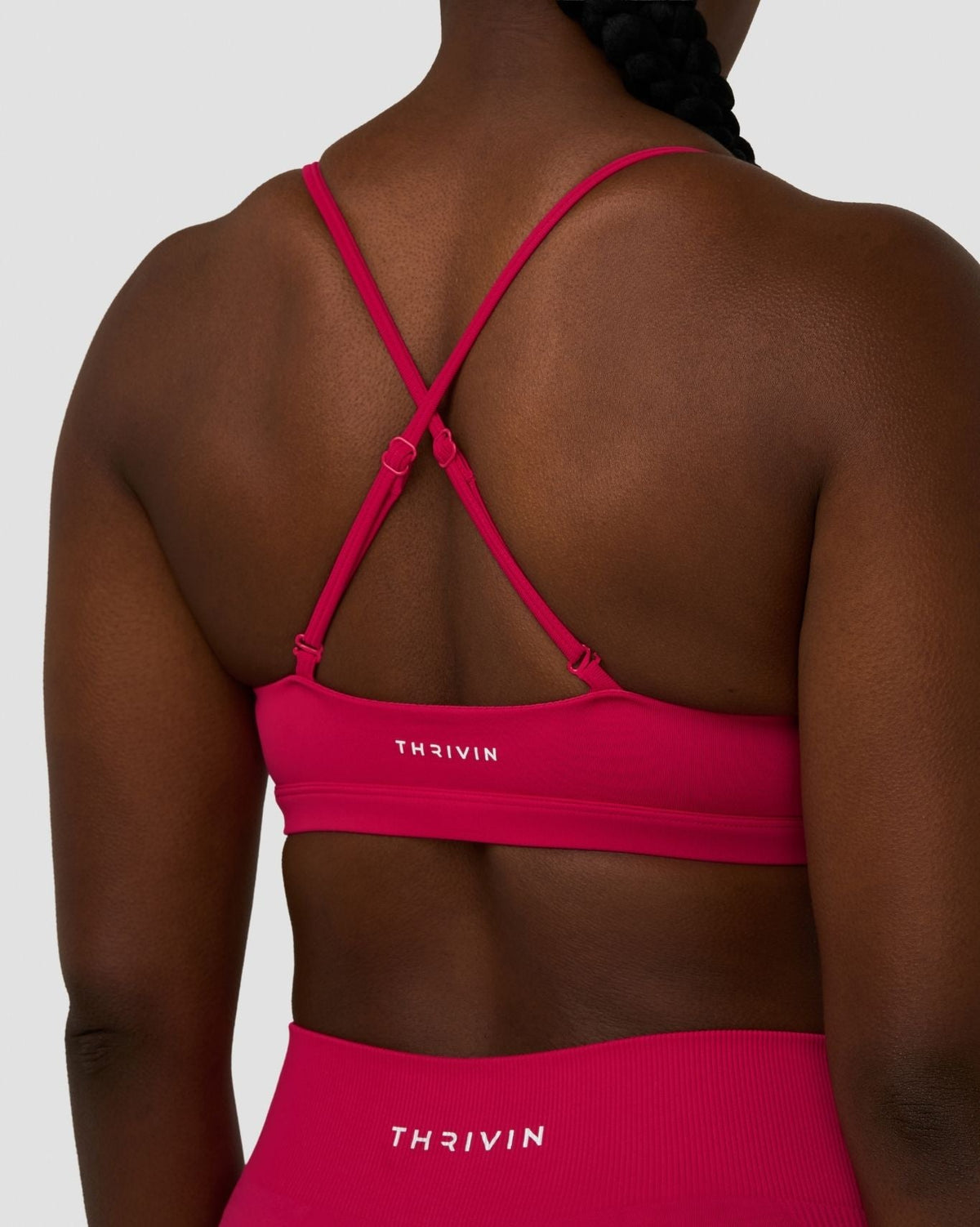 Elevate Sculpting Seamless Scoop Neck Bra in Strawberry, back close-up of crossover straps and THRIVIN logo band