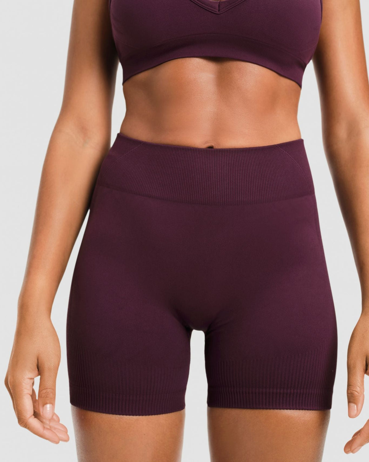 Elevate Sculpting Mid Waist Scrunch Shorter Shorts in Winter Plum Red, front close-up of ribbed waistband and sculpting knit