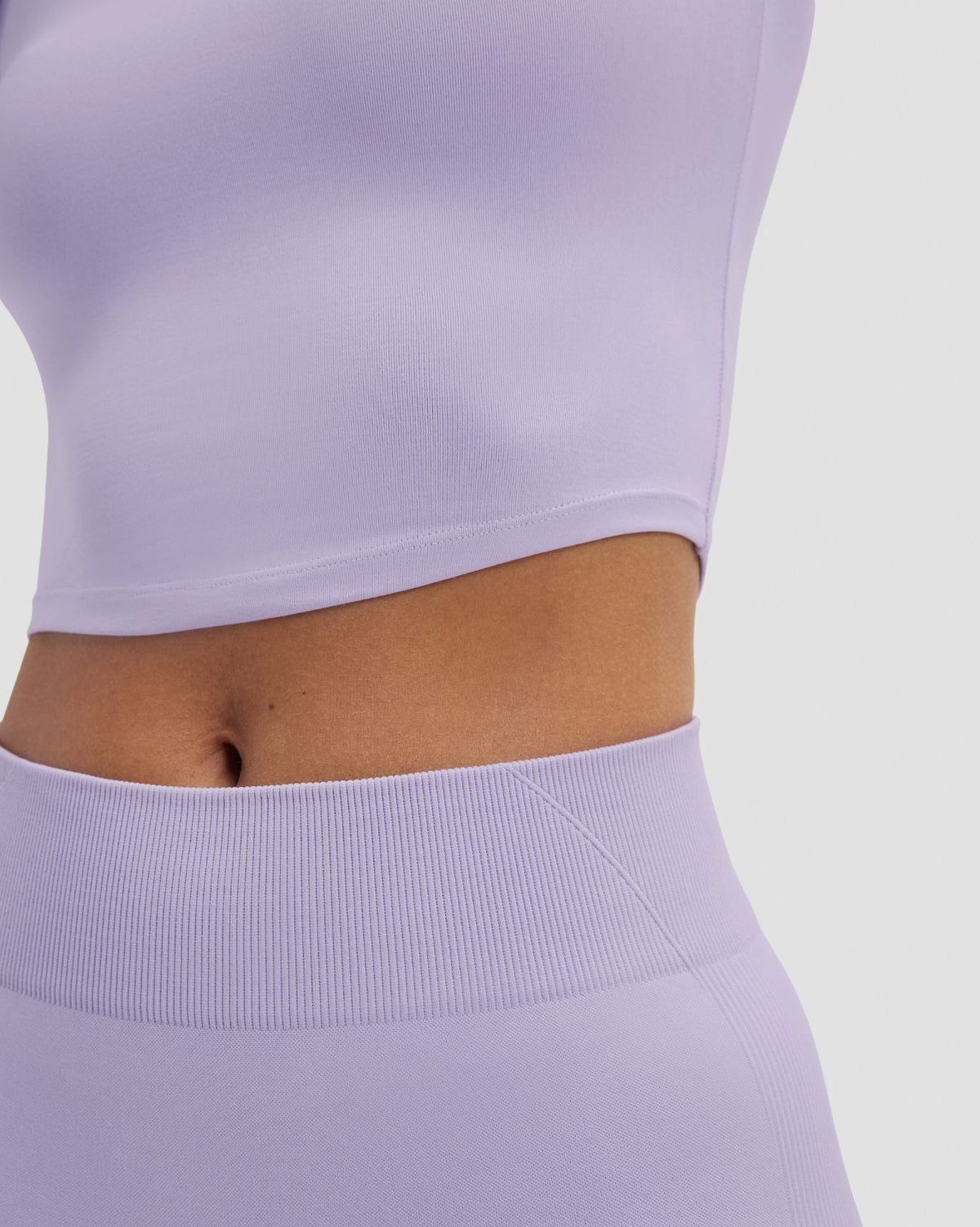 Elevate Compression Long Sleeve Top in Lilac, close-up of cropped hem and waistband