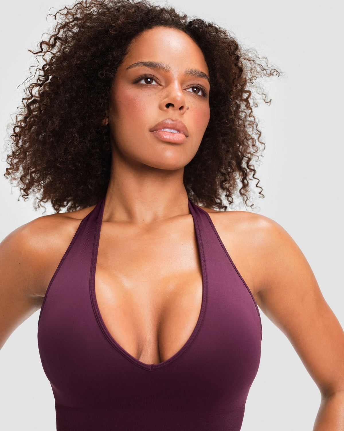 Elevate Sculpting Seamless Halterneck Top in Winter Plum Red, front close-up of plunge V-neck and sculpting fit