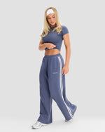 Wide Leg Striped Joggers in Steel Blue, full-length front view mid-stride showing relaxed wide leg and side stripe