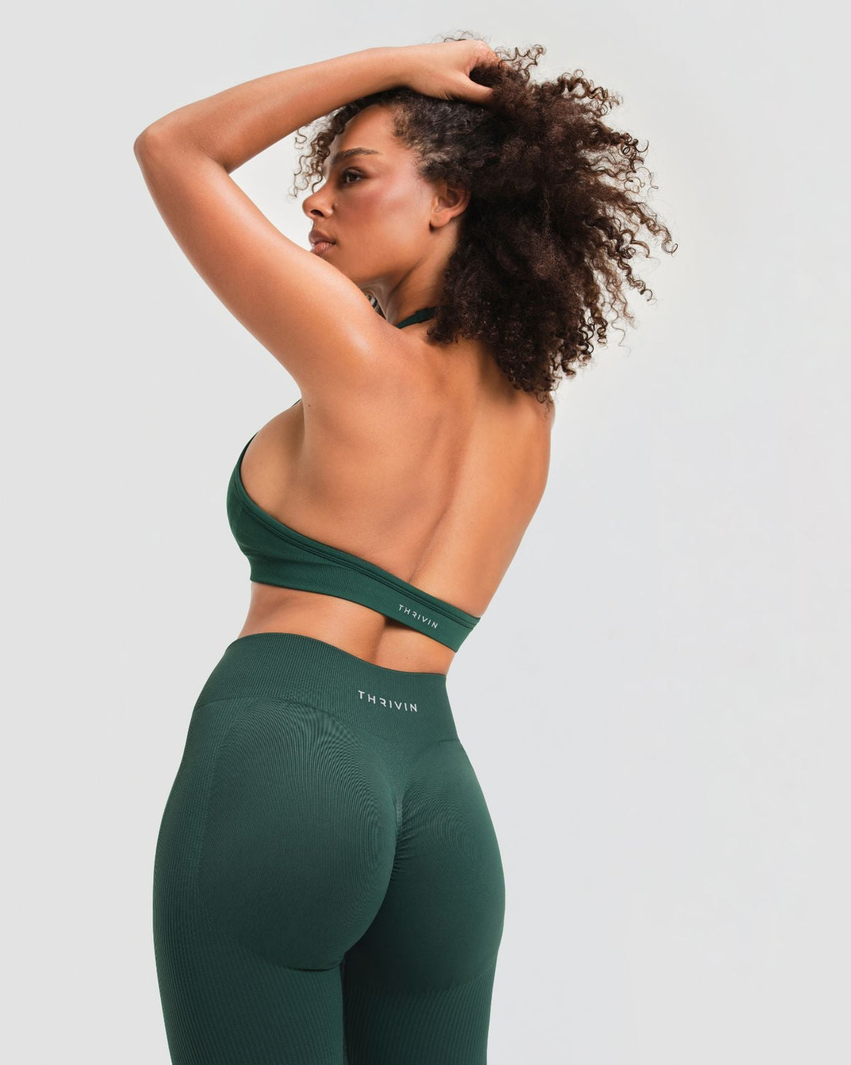Elevate Sculpting Mid Waist Scrunch Leggings in Pine Green, back view with THRIVIN logo waistband and scrunch seam