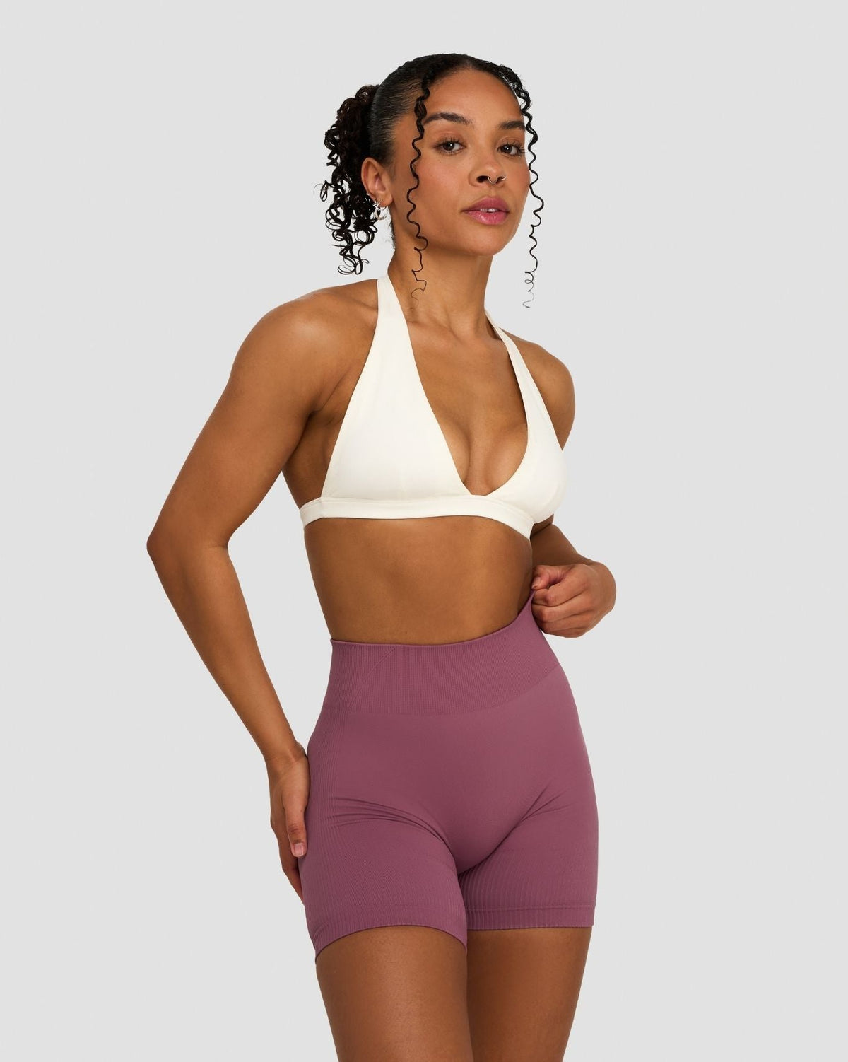 Elevate Sculpting Seamless V-Neck Halter Bra in Cream, front view of halter neck, styled with shorts