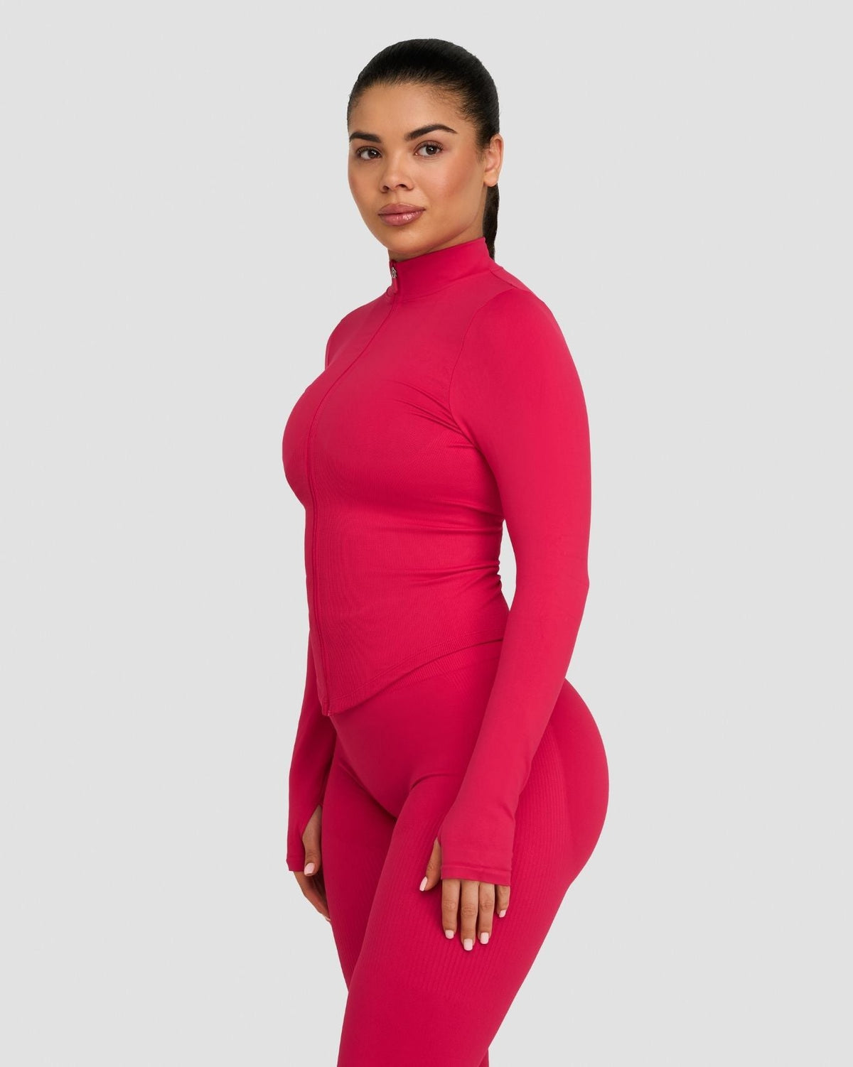 Elevate Compression Long Sleeve Jacket in Strawberry, side view with thumbhole sleeve