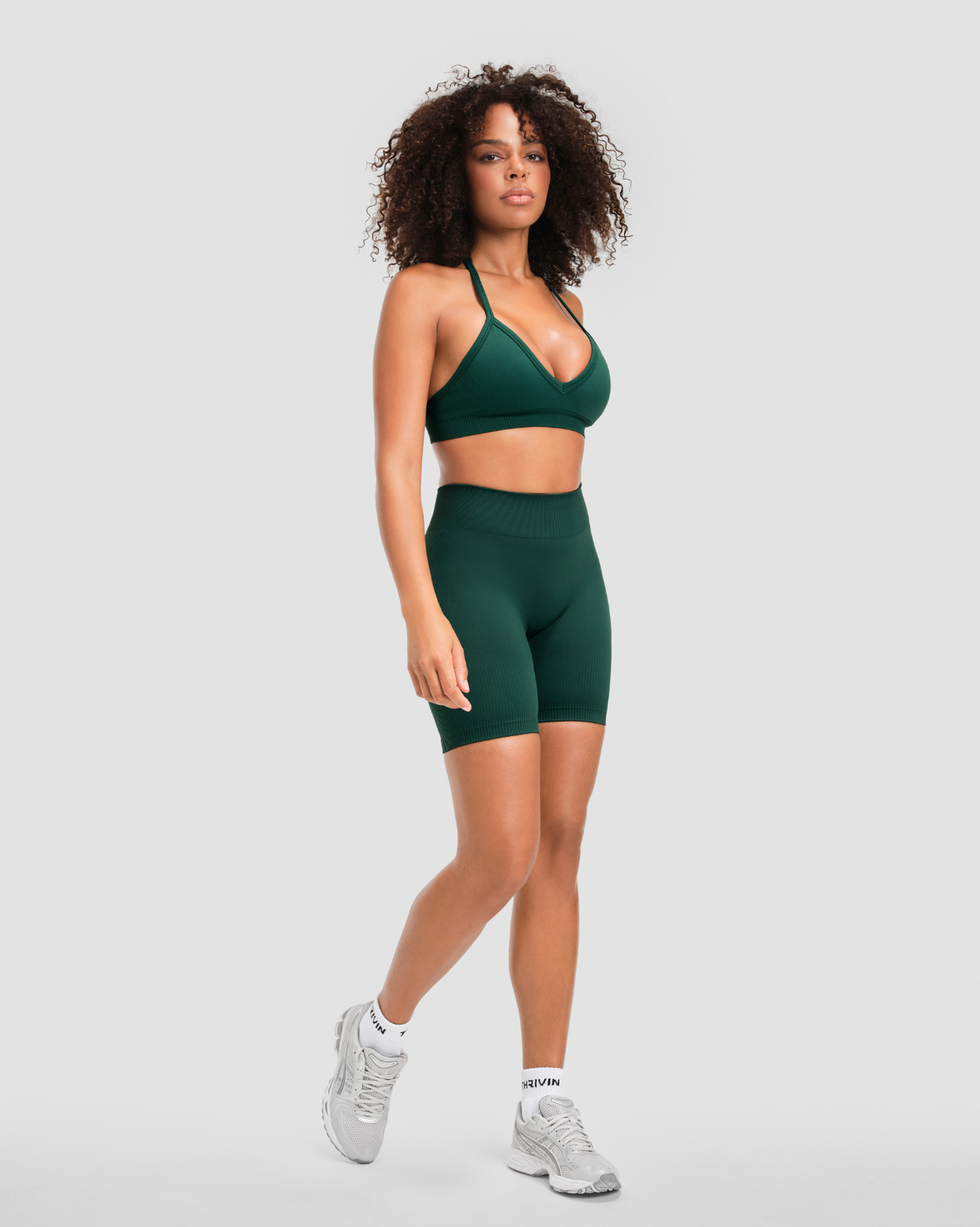 Elevate Sculpting Mid Waist Scrunch Shorts in Pine Green, full-length front view with high waistband and ribbed knit