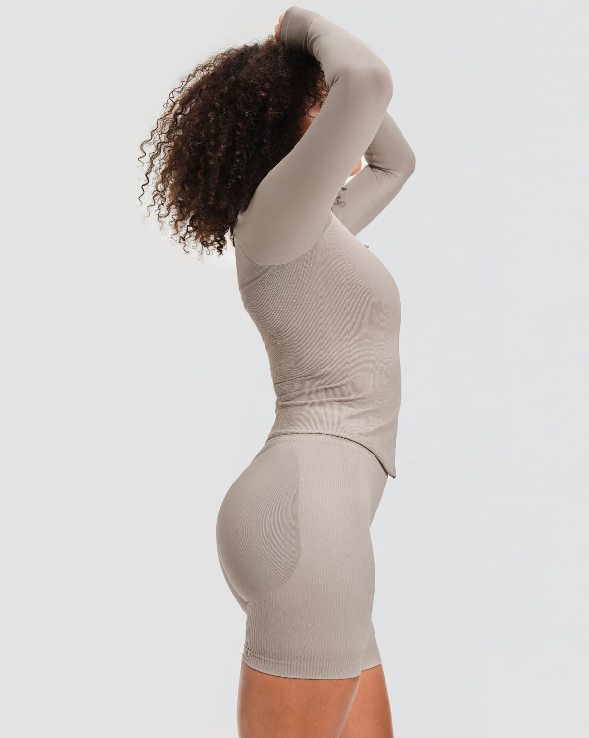 Elevate Compression Long Sleeve Jacket in Latte Grey, side view with ribbed knit and curved hem