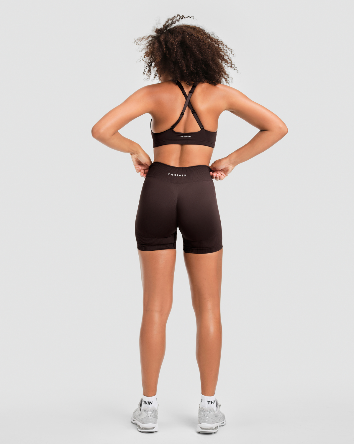 Elevate Sculpting Mid Waist Scrunch Shorter Shorts in Coffee Brown, back view with scrunch seam and Thrivin logo waistband