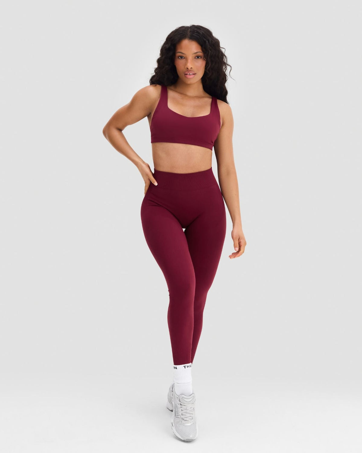 Elevate Sculpting Mid Waist Scrunch Leggings in Fine Wine Red, full-length front view, hand on hip