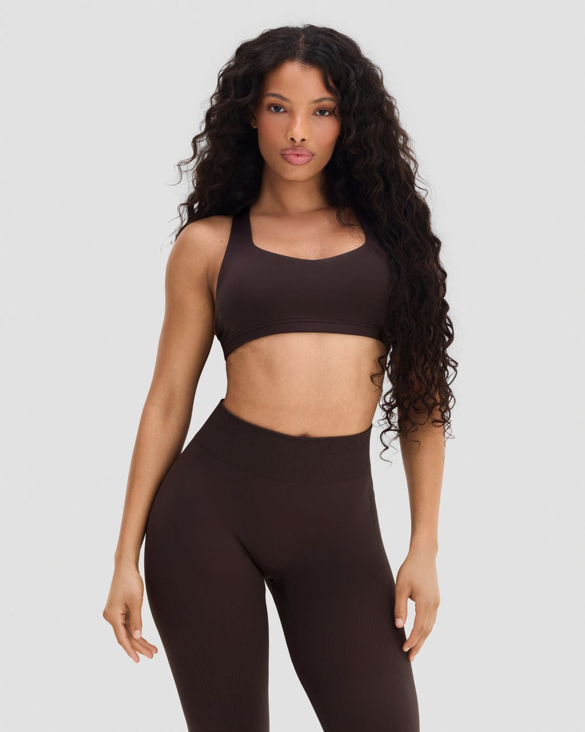 Elevate Sculpting Medium Impact Multiway Bra in Coffee Brown, front view styled with leggings