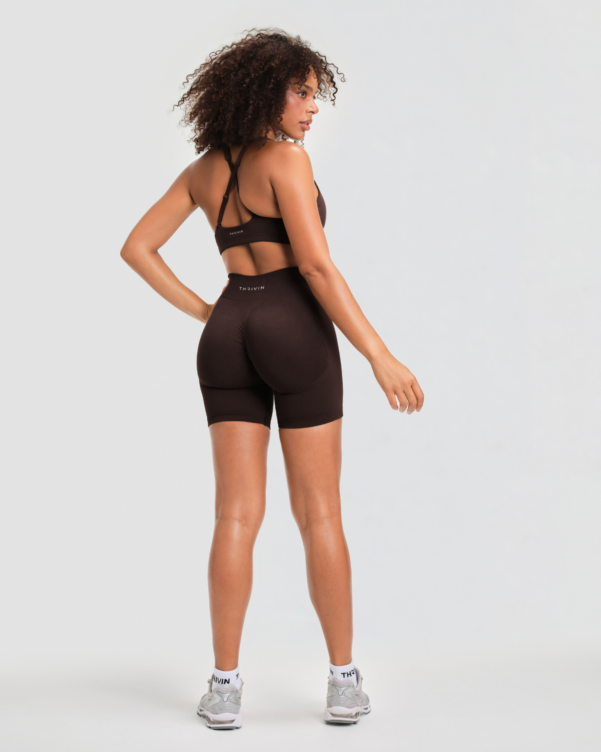 Elevate Sculpting Mid Waist Scrunch Shorts in Coffee Brown, back view with scrunch seam, THRIVIN logo and regular inseam